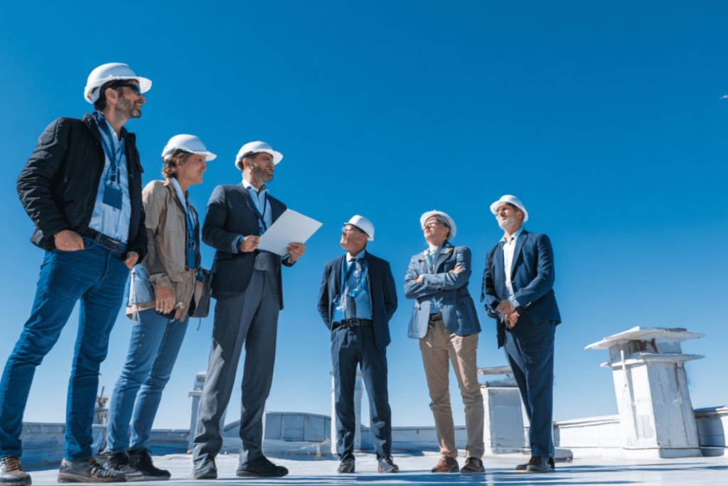 Roof Cooling Experts team member meeting with a commercial building owner to discuss roofing options.